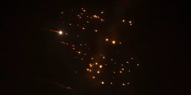 Rocket trails are seen in the sky amid a new barrage of Iranian missile attacks above the Israeli coastal city of Netanya, on March 18, 2026 [Jack Guez/AFP]