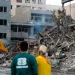 Residents inspect the aftermath of Israeli and US air strikes at Nilufar Square in the heart of the Iranian capital. [Fatemeh Bahrami/Anadolu]