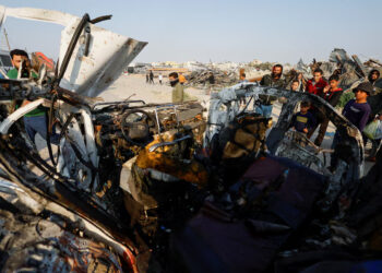 Palestinians inspect the site of an Israeli airstrike targeting a police vehicle in the central Gaza Strip, March 15, 2026. REUTERS/Mahmoud Issa Purchase Licensing Rights