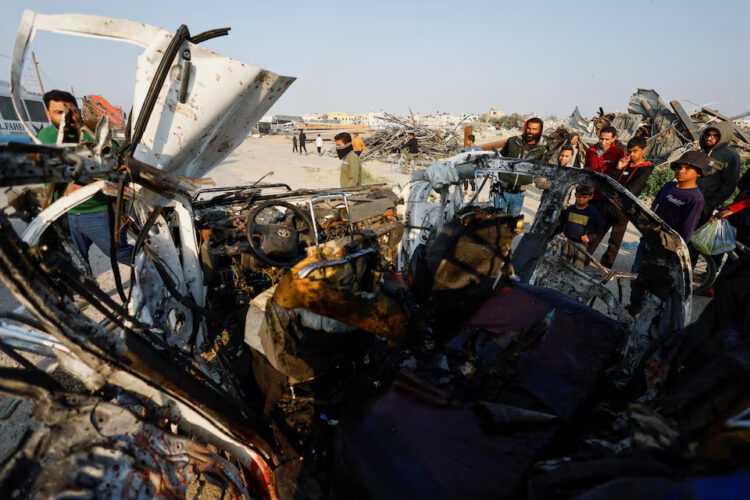 Palestinians inspect the site of an Israeli airstrike targeting a police vehicle in the central Gaza Strip, March 15, 2026. REUTERS/Mahmoud Issa Purchase Licensing Rights