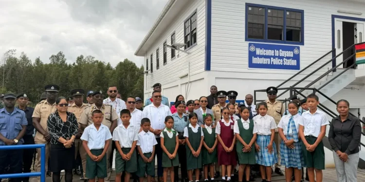 Minister of Home Affairs Oneidge Walrond (centre), along with regional officials and pupils