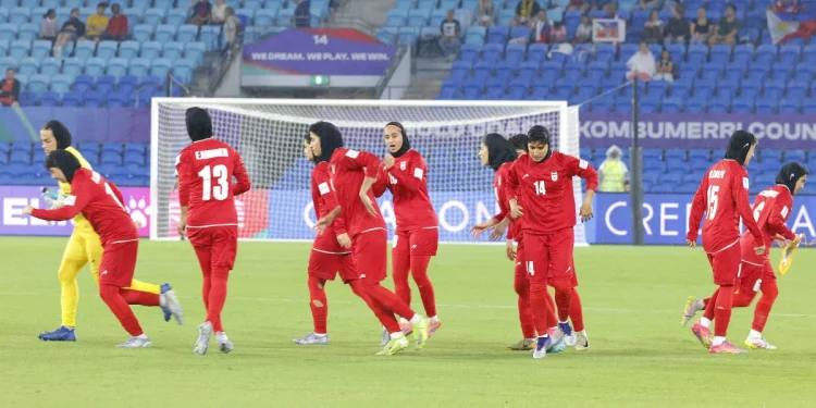 This photo taken on March 8, 2026 shows Iranian players running towards their positions at the start of the AFC Women's Asian Cup Australia 2026 football match between Iran and the Philippines on the Gold Coast.

STR/AFP/via Getty Images