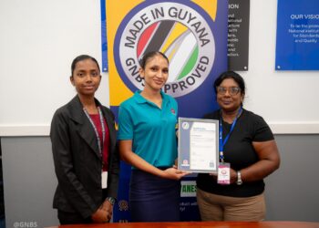 The-Made-in-Guyana-Certificate-being-handed-over-by-GNBS-Administrative-Clerk-Faith-Phillips-and-Technical-Officer-Rachel-Cecil-to-the-Proprietor-of-BR-Products-Budwatty