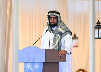 President Irfaan Ali, wearing the keffiyeh. while delivering the feature address to the gathering at the Muslim Youth Organisation