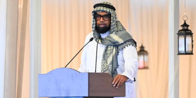 President Irfaan Ali, wearing the keffiyeh. while delivering the feature address to the gathering at the Muslim Youth Organisation