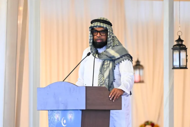 President Irfaan Ali, wearing the keffiyeh. while delivering the feature address to the gathering at the Muslim Youth Organisation