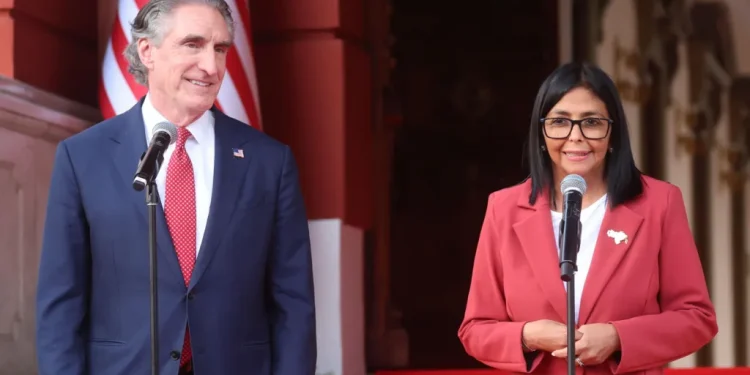 Venezuela's interim president Delcy Rodríguez (R) speaks alongside US Secretary of the Interior Doug Burgum in Caracas