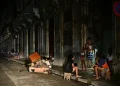 Cubans chat at night on a street during a nationwide blackout caused by a grid failure in Havana on October 18, 2024. Alberto Roque/AFP via Getty Images