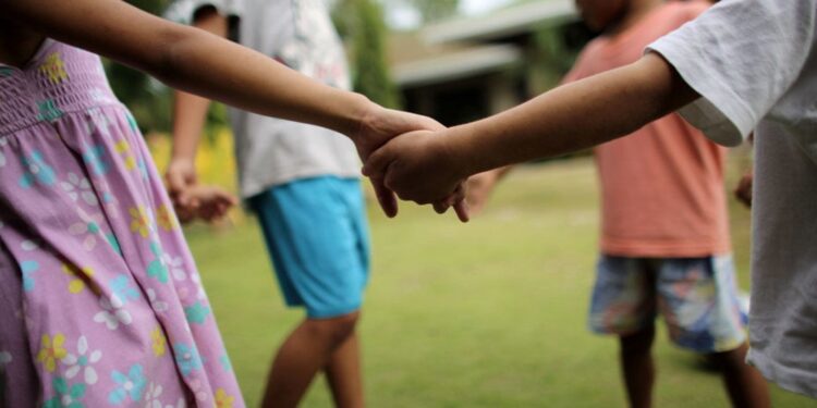 UNICEF/Joshua Estey Children play outside their home at a shelter in the Philippines.