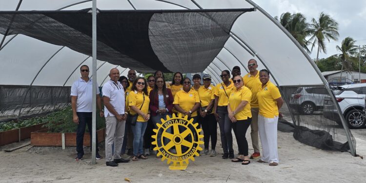 Members of the Rotary Club of Garden City Georgetown with visiting District Governor,  Assistant Governor and members of the Club standing in front of the Shade Tunnel