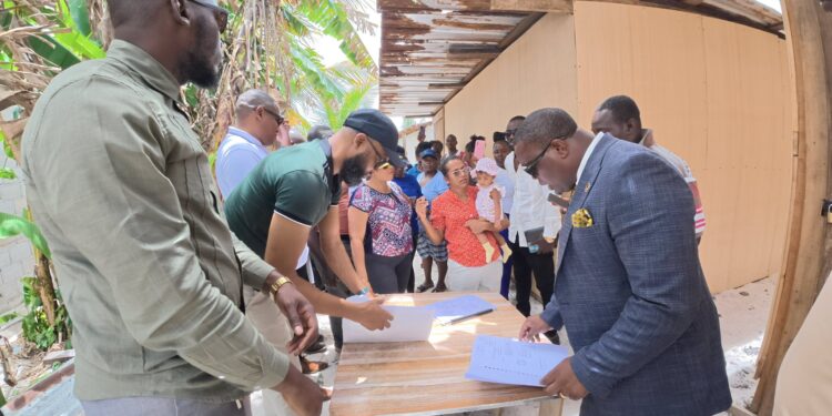 Residents of Friendship EBD residents with APNU MPs attorney-at-law Dr. Dexter Todd (in suit) and Saiku  Andrews (black cap) APNU face book photo
