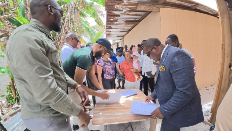 Residents of Friendship EBD residents with APNU MPs attorney-at-law Dr. Dexter Todd (in suit) and Saiku Andrews (black cap) APNU face book photo