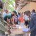 Residents of Friendship EBD residents with APNU MPs attorney-at-law Dr. Dexter Todd (in suit) and Saiku Andrews (black cap) APNU face book photo