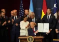 President Donald Trump holds up a newly signed proclamation committing to countering cartel criminal activity at the Shield of the Americas Summit on March 7, 2026, at Trump National Doral Miami in Doral, Florida. | Rebecca Blackwell/AP