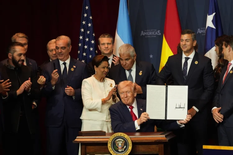 President Donald Trump holds up a newly signed proclamation committing to countering cartel criminal activity at the Shield of the Americas Summit on March 7, 2026, at Trump National Doral Miami in Doral, Florida. | Rebecca Blackwell/AP