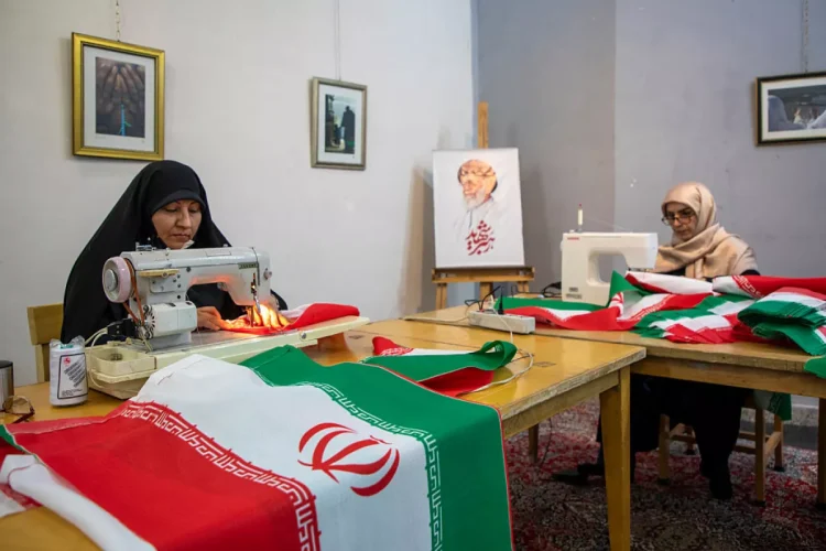 Volunteers sew Iranian flags to distribute across the city for free in Tehran, Iran, on Sunday. According to the team's manager, up to 5,000 flags are distributed daily.
Majid Saeedi/Getty Images