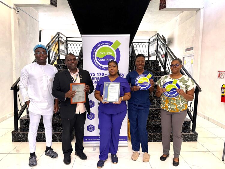 (L-R) Chief Executive Officer and Medical Officer, Dr Allan Outridge, of Empire Medical Centre Laboratory and other staff of the laboratory with the GYS 170 Certificate