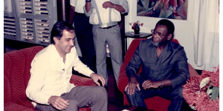 The late Roderick Rainford, former Secretary-General of CARICOM (r) in discussion with a visitor