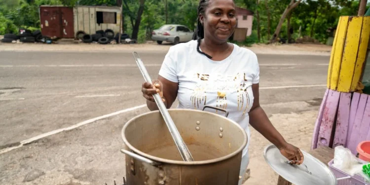 Sean Blake, who runs a cookshop at Gutters received a stove and other inputs to restart her business. She is back on her feet serving up customers