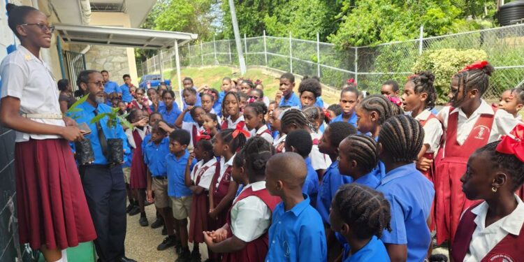 United Nations Anthurium Lewis (left) addresses pupils at a school in Tobago.
