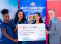 Ministry of Human Services and Social Security Dr Vindhya Persaud, alongside IDB Country Representative Lorena Salazar and Political Counsellor at the High Commission of Canada, Daniel Bood, handing over the grant