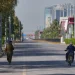 An Army soldier, left, walk as a police officer drives motorcycle on an empty road ahead of  second round of negotiations between U.S. and Iran, in Islamabad, Pakistan Monday April 20, 2026 (AP Photo/ Amjum Naveed)