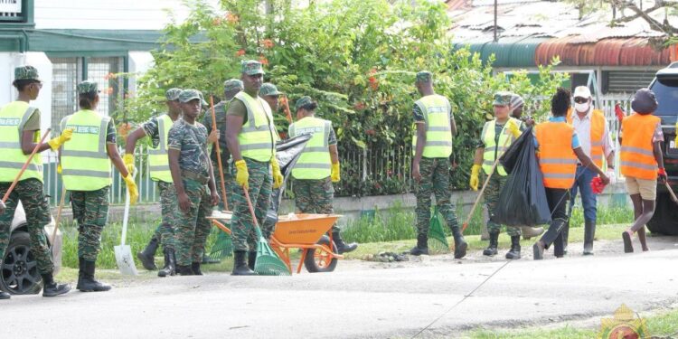 Members of the Guyana Defence Force cleaning the streets of Georgetown