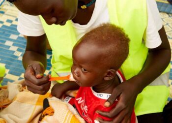 © UNICEF A child in South Sudan is fed by a healthcare worker.