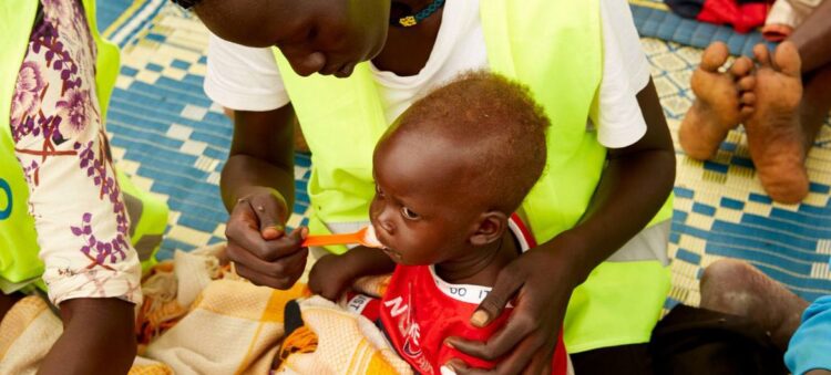 © UNICEF A child in South Sudan is fed by a healthcare worker.