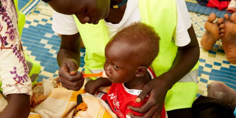 © UNICEF A child in South Sudan is fed by a healthcare worker.