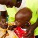 © UNICEF A child in South Sudan is fed by a healthcare worker.