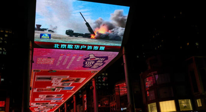 A giant screen shows a news report on China's "Justice Mission 2025" military drills around Taiwan, in Beijing, China, 30 December 2025. REUTERS