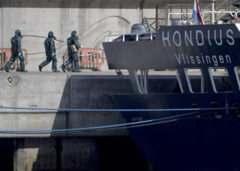 People wearing protective suits walk towards the MV Hondius as it was docked in port in Tenerife on Monday. Photograph: Jorge Guerrero/AFP/Getty Images