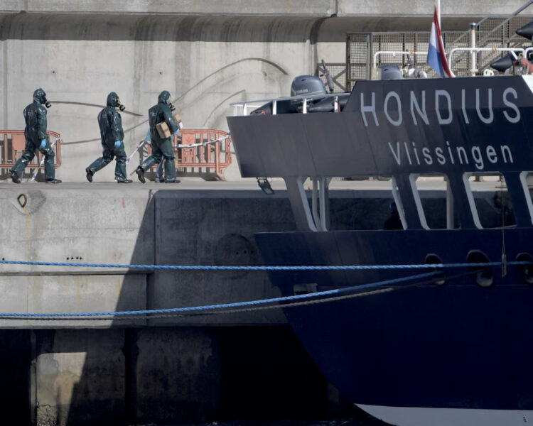 People wearing protective suits walk towards the MV Hondius as it was docked in port in Tenerife on Monday. Photograph: Jorge Guerrero/AFP/Getty Images