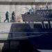 People wearing protective suits walk towards the MV Hondius as it was docked in port in Tenerife on Monday. Photograph: Jorge Guerrero/AFP/Getty Images