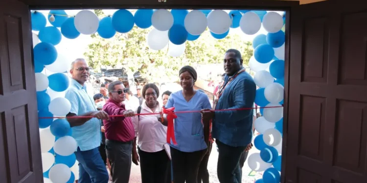 Minister of Health Dr Frank Anthony, flanked by regional officials, cuts the ceremonial ribbon for the drugs bond