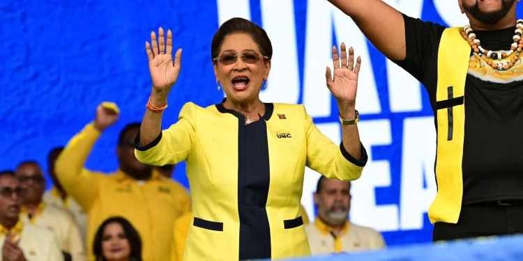 IN A CELEBRATORY MOOD: Prime Minister Kamla Persad-Bissessar makes a joyful noise as she celebrates on Saturday at the UNC’s congress meeting and one-year anniversary celebration in Couva. —Photo: JERMAINE CRUICKSHANK