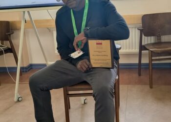 Dr. Lidon Lashley proudly displays his Award for Excellence in Research Review and Analysis at the 2026 International Association for Laboratory Schools (IALS) Conference in Finland.