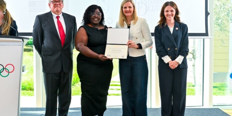 ICECP Program Kenisha Headley receiving certificate from IOC President Kirsty Coventry