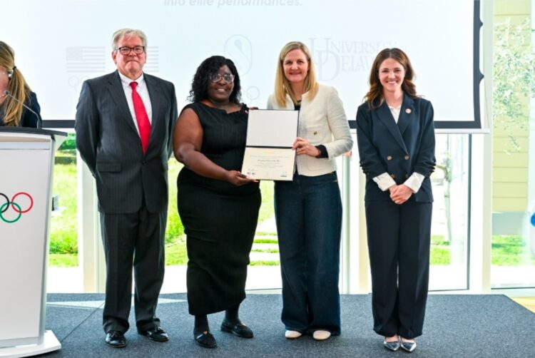 ICECP Program Kenisha Headley receiving certificate from IOC President Kirsty Coventry