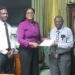 FGM Parliamentarian Amanza Walton-Desir hands over petition to Clerk of the Assembly Sherlock Isaacs