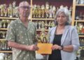 Trophy Stall proprietor, Ramesh Sunich presents sponsorship cheque to GCF’s Company Secretary Marcia Lee at Trophy Stall South Road