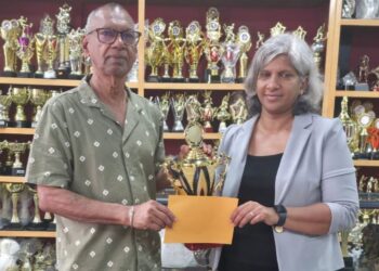 Trophy Stall proprietor, Ramesh Sunich presents sponsorship cheque to GCF’s Company Secretary Marcia Lee at Trophy Stall South Road