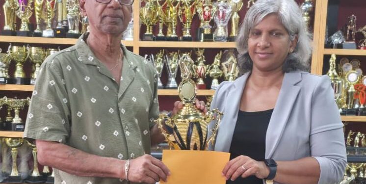 Trophy Stall proprietor, Ramesh Sunich presents sponsorship cheque to GCF’s Company Secretary Marcia Lee at Trophy Stall South Road