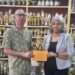 Trophy Stall proprietor, Ramesh Sunich presents sponsorship cheque to GCF’s Company Secretary Marcia Lee at Trophy Stall South Road
