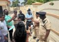 WIN Leader and Leader of the Opposition, Azruddin Mohamed surrounded by the Police and media during today's seizure of his firearms