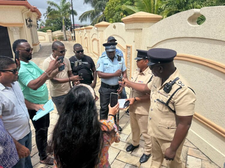WIN Leader and Leader of the Opposition, Azruddin Mohamed surrounded by the Police and media during today's seizure of his firearms