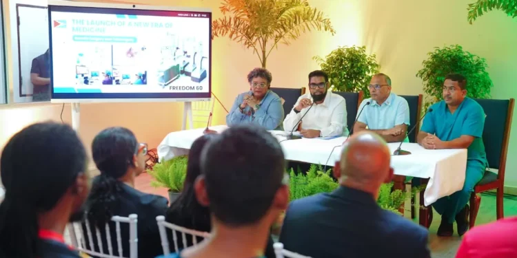 President Dr Mohamed Irfaan Ali, flanked by Barbados Prime Minister Mia Mottley and Minister of Health Dr Frank Anthony, and a member of the surgical team, speaking with reporters