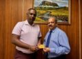Managing Director of Assuria Guyana, Mr. Yogindra Arjune presents the first Assuria Executive Lounge Pass to Governor of Bank of Guyana, Dr. Gobind Ganga on May 12th 2026 at the Bank of Guyana.