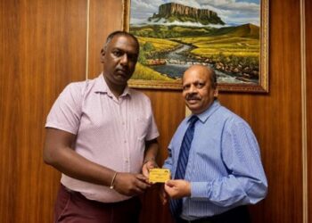 Managing Director of Assuria Guyana, Mr. Yogindra Arjune presents the first Assuria Executive Lounge Pass to Governor of Bank of Guyana, Dr. Gobind Ganga on May 12th 2026 at the Bank of Guyana.